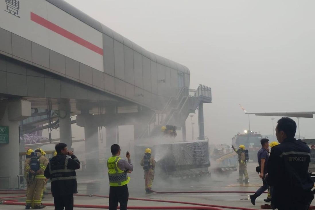 Photo from a Hong Kong Aviation Discussion Board group. Firefighters tackle a blaze on a cargo pallet as it awaited loading onto a Hong Kong Airlines plane bound for Taipei. Source: Facebook.