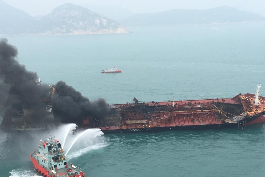 A fireboat battles the blaze aboard the Aulac Fortune as black smoke billows from below decks. A huge hole in the bow can also be seen. Photo: Handout