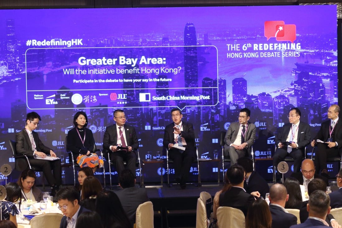 Post moderators Tony Cheung, Senior Political Reporter (left) and Yonden Lhatoo, Chief News Editor (right) with panellists Dr Yifan Hu, Regional Chief Investment Officer & Chief China Economist at UBS Global Wealth Management; Prof. Witman Hung, Principal Liaison Officer for Hong Kong at The Shenzhen Qianhai Authority; Albert Ng, Chairman of China and Managing Partner of Greater China at EY; Denis Ma, Head of Research for Hong Kong at JLL and Joseph Chan, Chairman of the Silk Road Economic Development Research Center speak at Greater Bay Area: Will the initiative benefit Hong Kong?
