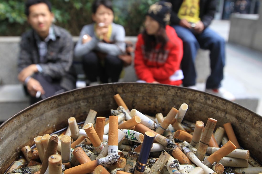 Smokers out in the open outside the Immigration Tower in Wanchai on 20 January 2011. Photo: SCMP