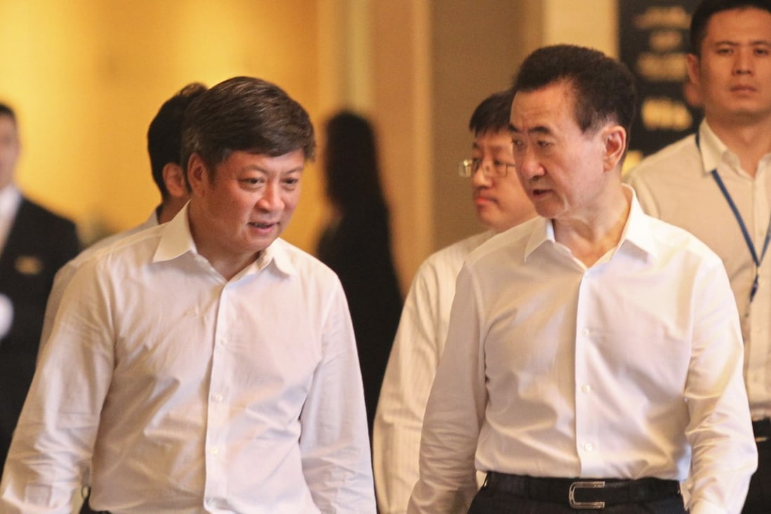 Sun Hongbin (1st left), chairman of Sunac China; and Wang Jianlin, Chairman of Wanda Group, arrive for the signing ceremony of Wanda’s sale of its hotel and tourism portfolio for 63 billion yuan to Sunac China in Beijing on July 19, 2017. Photo: SCMP/Simon Song