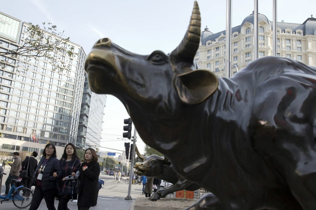 A sharp sell-off in Sanan Optoelectronics on Wednesday underscores the cautious mood among investors in Shanghai. Pedestrians walk past a statue of a bull in Beijing on November 8, 2017. Photo: AP