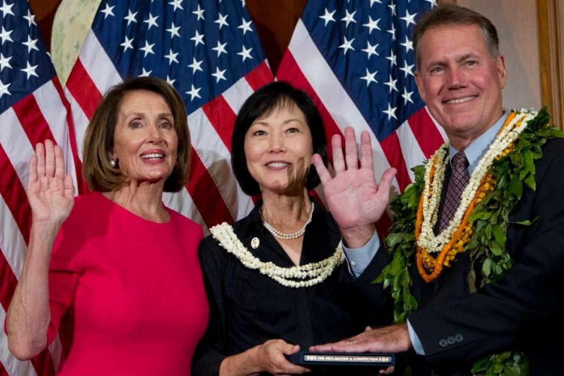 US Representative Ed Case is sworn in on January 3 by House speaker Nancy Pelosi (left), as Case's wife, Audrey Nakamura, looks on. Photo: AP