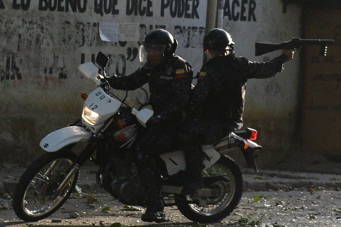 Riot policemen on a motorcycle during clashes with anti-government demonstrators in Caracas, on January 21, when a group of soldiers rose up against Venezuela's President Nicolas Maduro. Photo: AFP