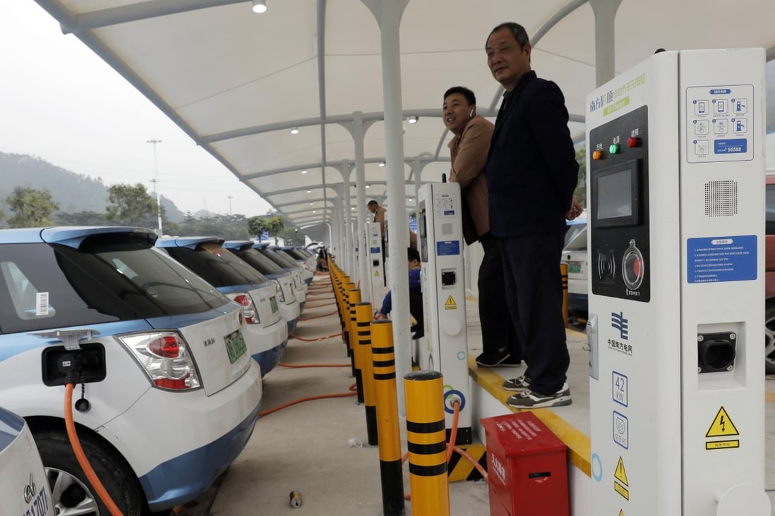New electric taxis at a public charging station in Shenzhen, south China. Photo: AP