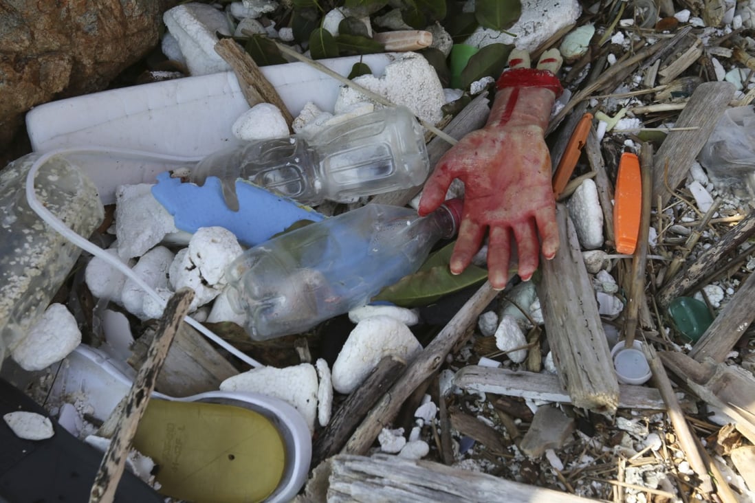 Rubbish, including a model of a bloodied hand, at a beach in the far corner of Big Wave Bay in the Hong Kong village of Shek O. Photo: Xiaomei Chen