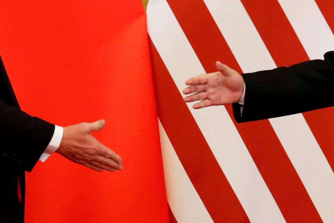 US and Chinese presidents Donald Trump and Xi Jinping reach for a handshake in Beijing on November 9. 2017. Photo: Reuters  FILE PHOTO: U.S. President Donald Trump and China's President Xi Jinping shake hands after making joint statements at the Great Hall of the People in Beijing, China, November 9, 2017. REUTERS/Damir Sagolj/File Photo/File Photo