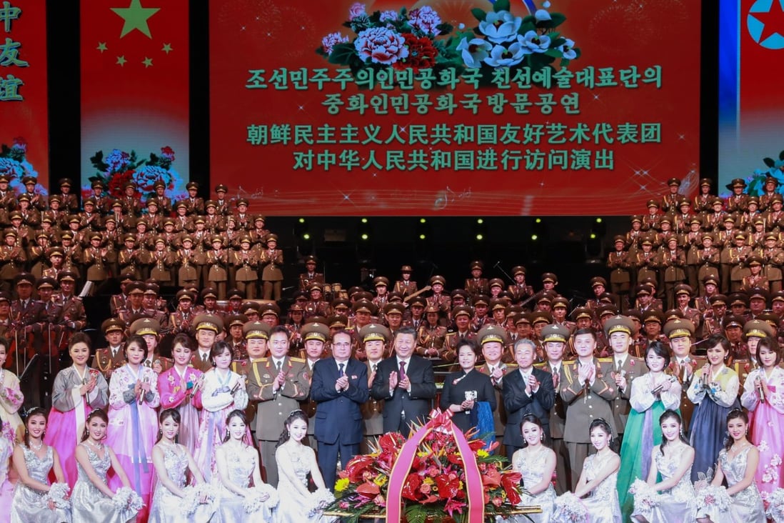 Xi Jinping and his wife Peng Liyuan join performers on stage in Beijing on Sunday. Photo: Xinhua