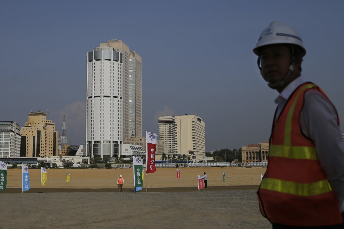 A Chinese construction worker stands on land that was reclaimed from the Indian Ocean for the Colombo Port City project in Sri Lanka’s capital. Photo: AP