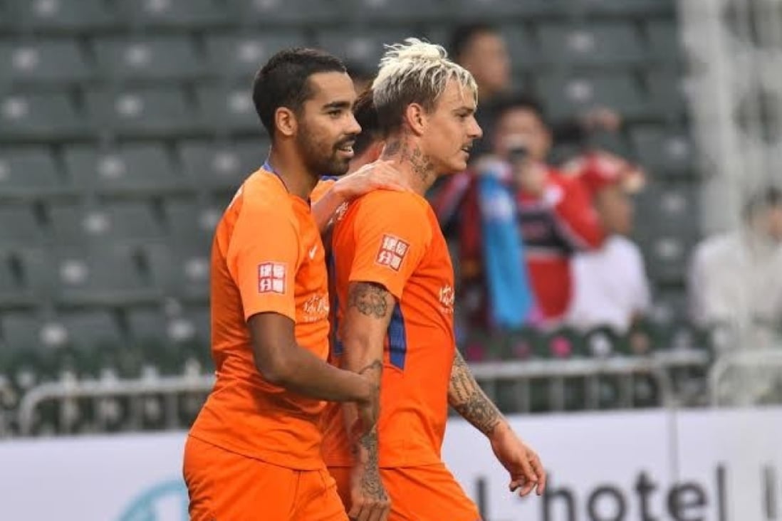 Roger Guedes is congratulated by teammates after scoring for Shandong Luneng. Photo: HKFA