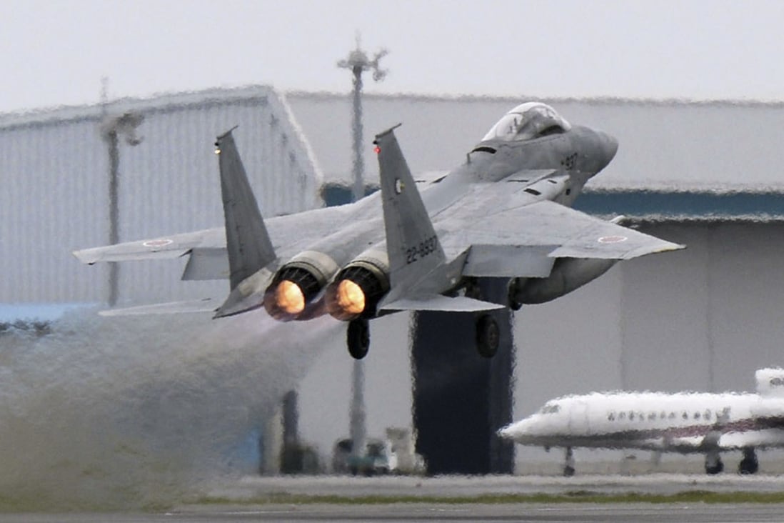 A Japanese F-15 fighter scrambles at the Air Self Defence Force Naha base in Okinawa, Japan. Photo: Reuters