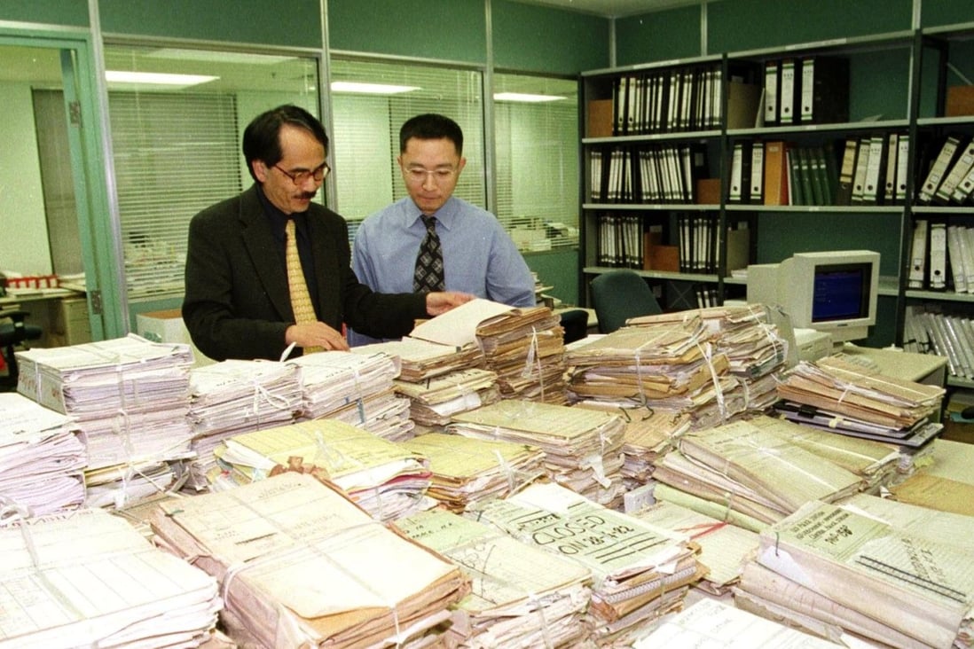 Then Government Records Services director Simon Chu (left) and his staff appraise government records transferred to the Public Records Office in 1999. Photo: Information Services Department