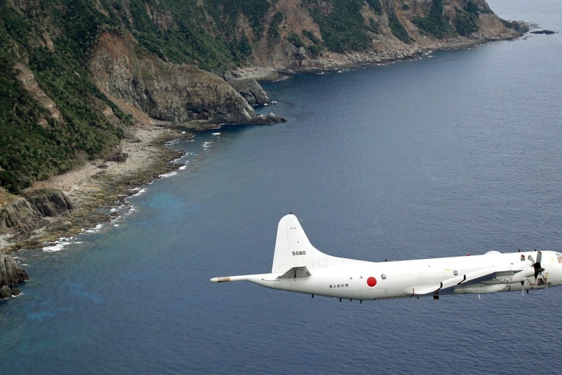 A Japanese surveillance plane flies over the disputed islands in the East China Sea, called the Senkaku in Japan and Diaoyu in China. Photo: AP