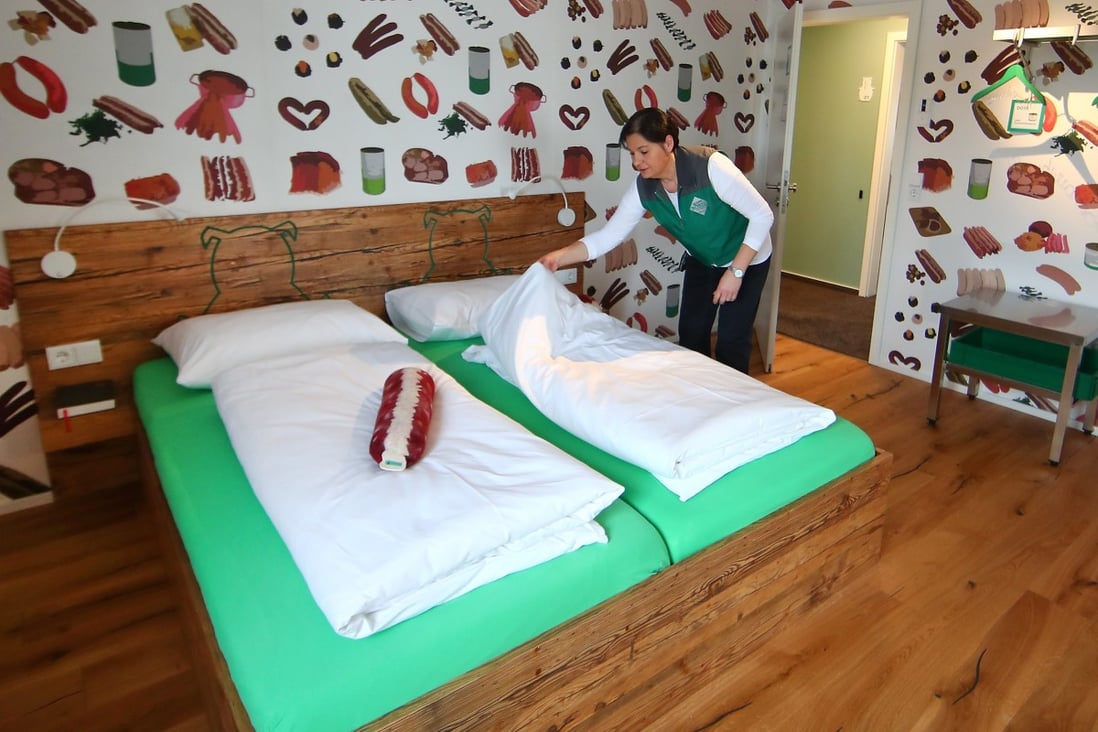 A room of the Bratwurst Hotel in Rittersbach near Nuremberg, Germany, with a sausage-shaped pillow and sausage-themed wallpaper. Photo: Reuters