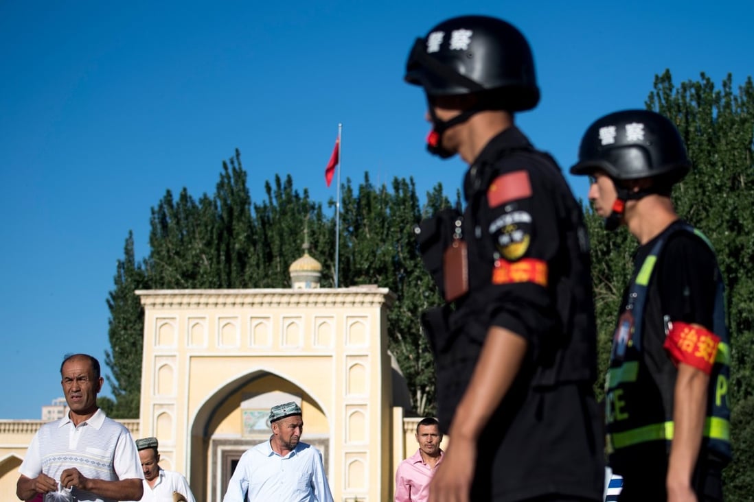 Police patrol outside the Id Kah Mosque in Kashgar, Xinjiang, after morning prayers. Photo: AFP