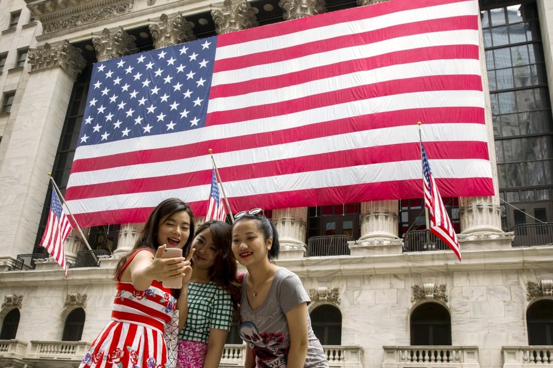 Chinese tourists take a selfie outside the New York Stock Exchange. Photo: Reuters