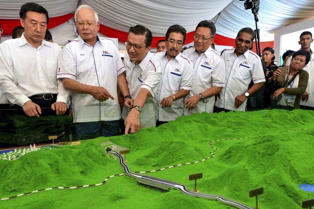 Malaysia’s former prime minister Najib Razak (third left) looks at models of the East Coast Rail Link in 2017 - the project was later scrapped by his successor Mahathir Mohamad because the US$20 billion cost of the deal was too much for the country to bear. Photo: AP