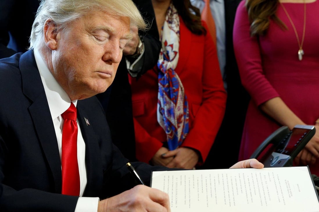 US President Donald Trump signs an executive order in the White House in this 2017 file photo. Photo: Reuters