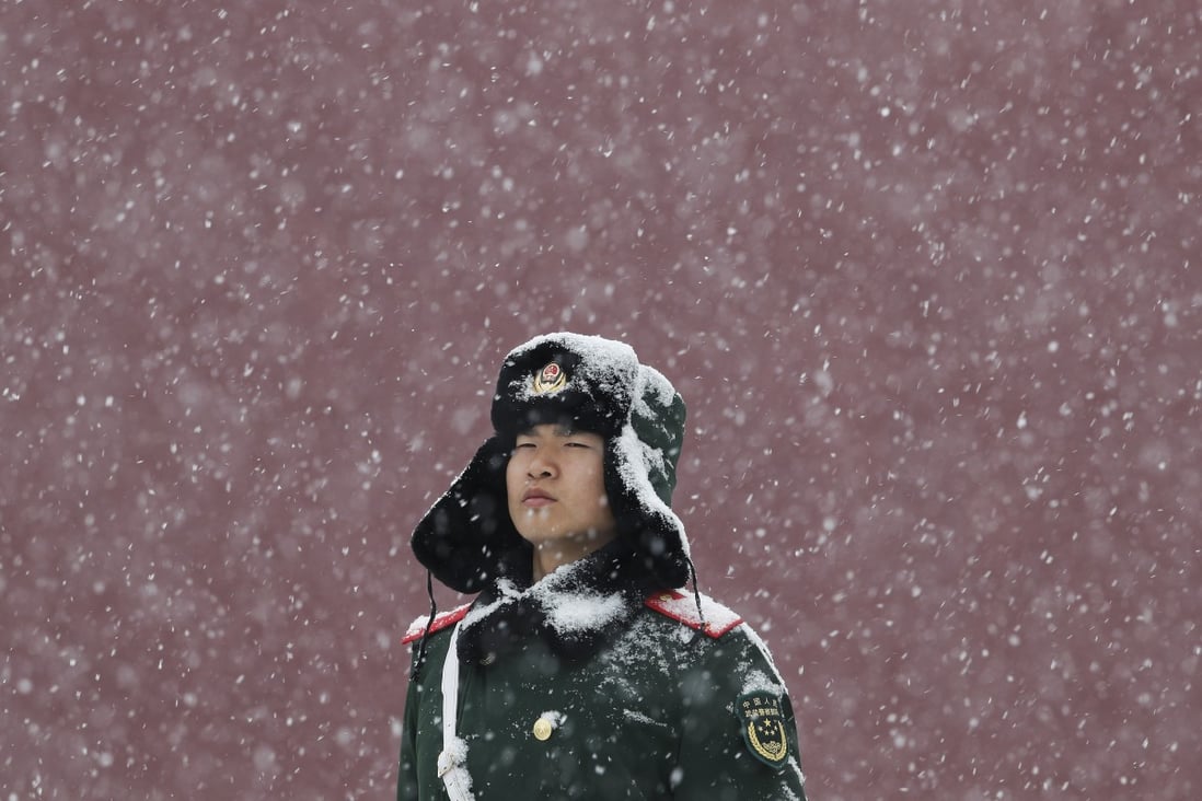 A paramilitary police officer stands guard outside Tiananmen as snow falls in Beijing on February 12. The Chinese civilisation has gone through many ups and downs in its history and learned many bitter lessons. Photo: AP