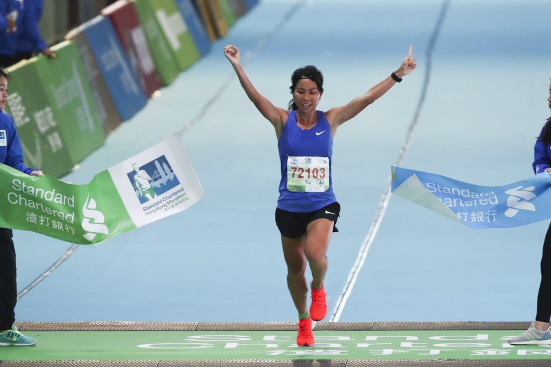 Christy Yiu Kit-ching wins the women’s half marathon at the Standard Chartered Hong Kong Marathon. Photos: Nora Tam