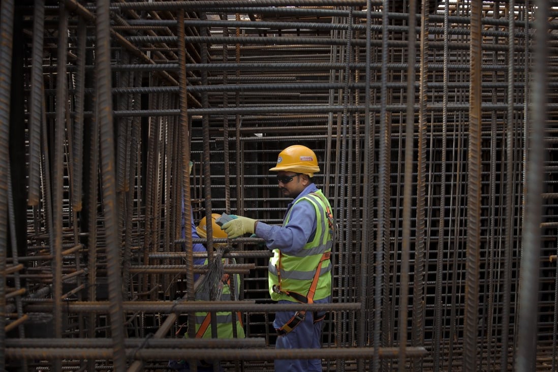 Builders working at the site of the Ras Abu Aboud stadium in Doha, Qatar. Photo: AP