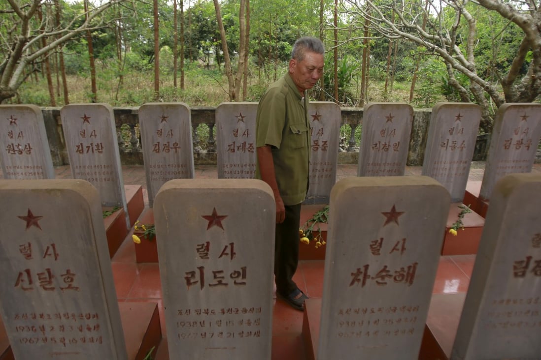 War veteran Duong Van Dau among the headstones at a memorial for North Korean fallen pilots in Bac Giang. Photo: AP