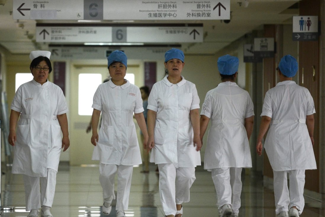 A group of nurses walks along a corridor at a hospital in Beijing. Photo: AFP