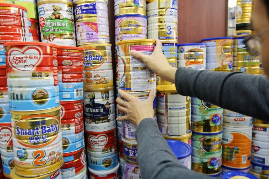 Tins of infant powder formula are seen at a pharmacy in Sheung Shui. 11DEC13