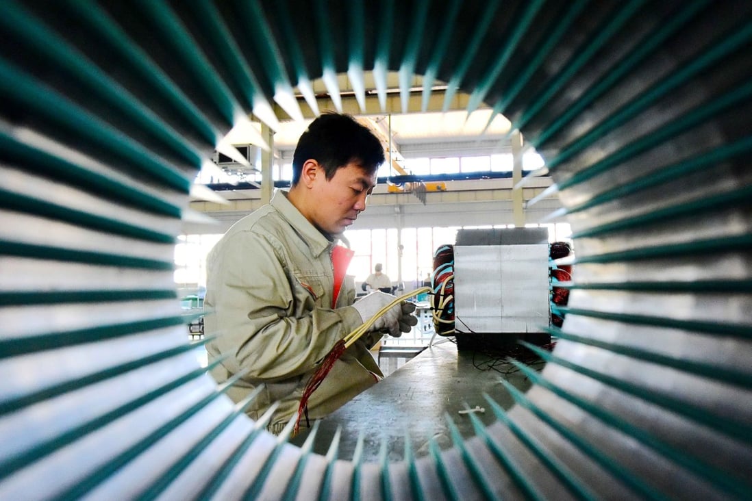 A man works on an electric machine parts at a workshop of an equipment manufacturing company in Weifang, Shandong province, China. Photo: Reuters