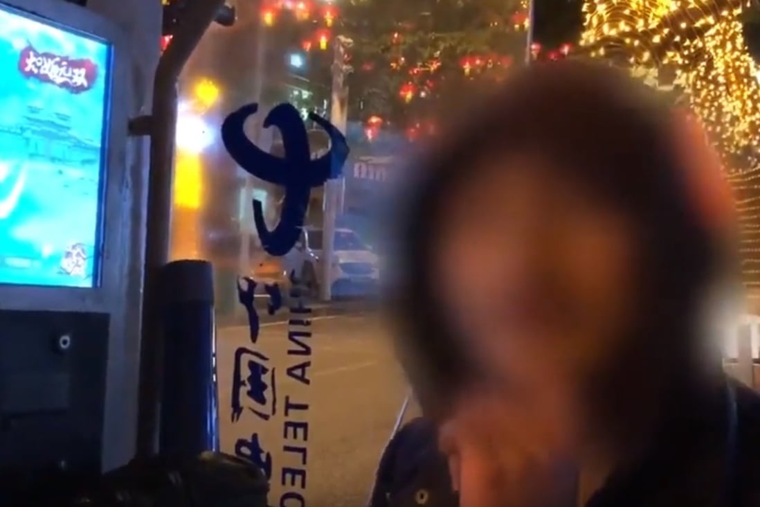 This Chinese man has for years hacked a phone booth in Chongqing for free movies and video games. Image: Pear Video via YouTube