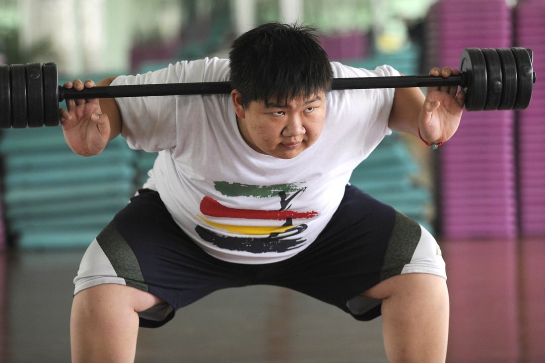 A man works out in Beijing. China’s public health crisis could cost the country trillions of dollars. Photo: AFP