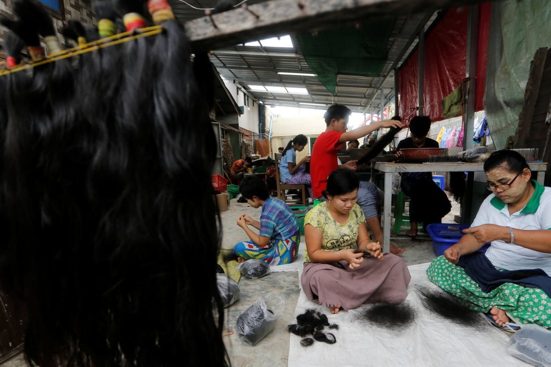 Workers clean hair for export in Yangon, Myanmar, in June 2018. Photo: Reuters