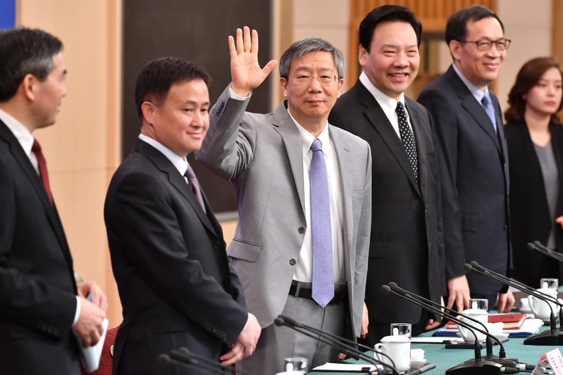 People's Bank of China governor Yi Gang (third left) said breaking up banking monopolies, improving bankruptcy laws and stricter enforcement of financial regulations could increase price transparency and reduce administrative fees. Photo: Xinhua