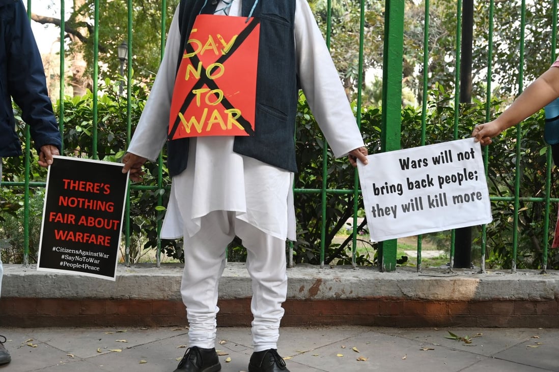Indian demonstrators hold placards as they form a human chain during an anti-war demonstration called by pacifist organisations in New Delhi on March 4. Photo: AFP