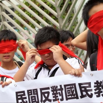 Students cover their eyes with red ribbons during a march against national education in Hong Kong on August 26, 2012. SCMP