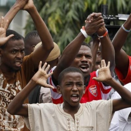 Young Kenyan Muslims shout against riot police officers in front of a mosque in Majengo area of the port city of Mombasa on Friday. Photo: EPA