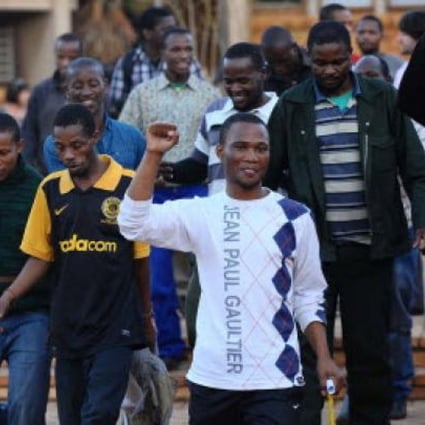 Mine workers celebrate their release at Ga-Rankuwa Magistrate's Court in Pretoria, South Africa, on Monday. Photo: AFP