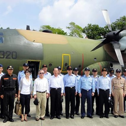 Three Taiwanese lawmakers, defence officials and members of the coastguard land on the island of Taiping in the Spratleys on Tuesday. Photo: AFP