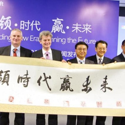 A group of Microsoft's executives hold a Chinese scroll at the company's press briefing in Beijing yesterday. Photo: Simon Song