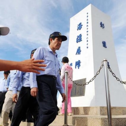 Taiwan President Ma Ying-jeou walks by a monument during an inspection of the Pengjia Islet in the East China Sea yesterday. Photo: AFP