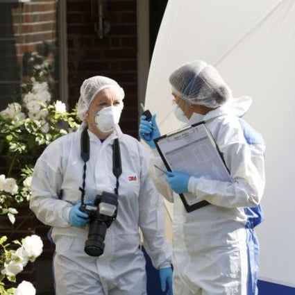 Police forensic officers conduct investigations outside the murdered family's home in Claygate, southern England. Photo: AFP