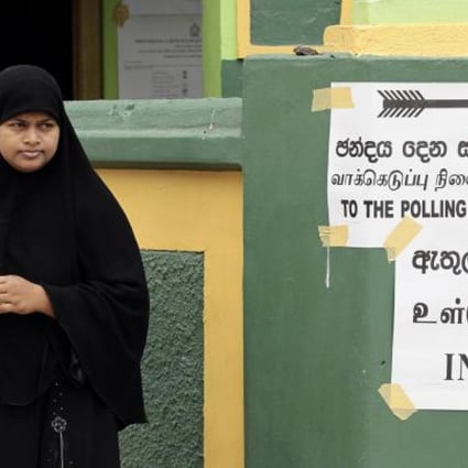A Sri Lankan woman outside a polling station. Photo: AP