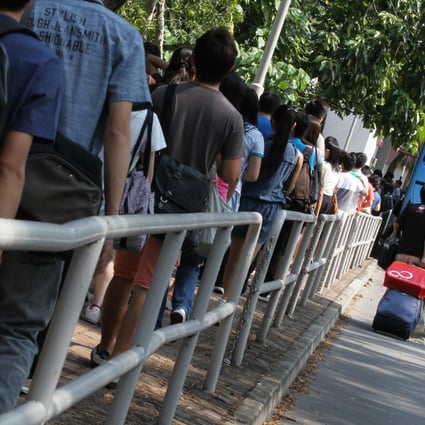 Students making their way to Chinese University queue for a shuttle bus near the University MTR station during a hectic first day of the academic year yesterday. Photo: Nora Tam