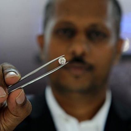 Suresh de Silva, director of the Belgrade International gem store, shows a 1.5-carat diamond similar to the one that was stolen. Photo: AFP