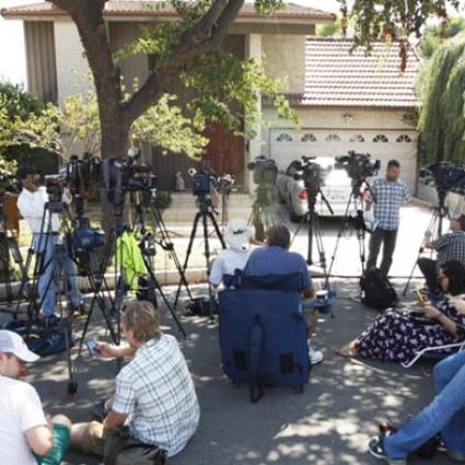 Reporters gather outside the house of a man thought to be associated with the production of the anti-Muslim movie, 'Innocence of Muslims', on Thursday in Cerritos, California. Photo: AFP