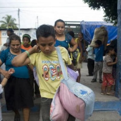 People evacuated from Morazan arrive at a shelter in a school of Santa Lucia Cotzumalguapa, 90km south of Guatemala City after their village was affected by ash released by the Volcan de Fuego. Guatemala's Volcano of Fire had its strongest eruption in a decade on Thursday. Photo: AFP