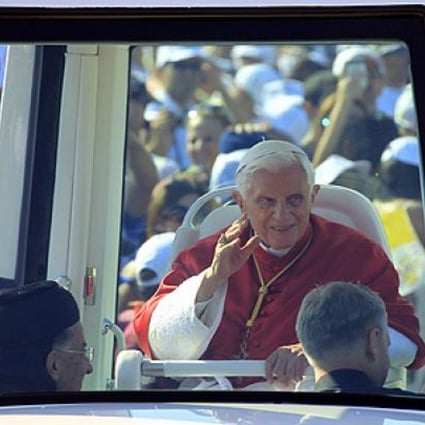 Pope Benedict XVI greets people from his popemobile in Bkerke on Sunday. Photo: AFP