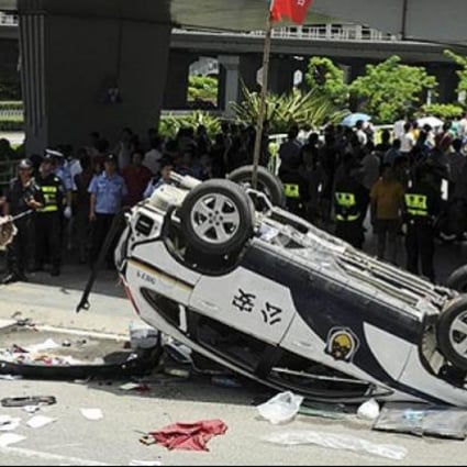A police car made by Honda is smashed up by anti-Japan protesters in August. Honda Motor said it had temporarily closed all five of its China plants after violent demonstrations. Photo: AP