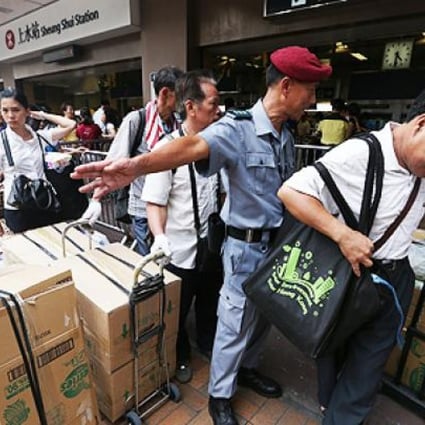 Parallel goods traders take their wares aboard the train at Sheung Shui railway station. Photo: Sam Tsang