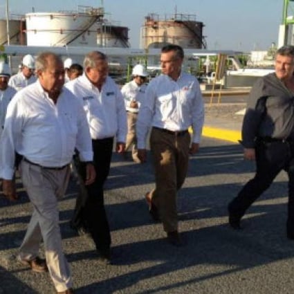  Director of Mexican state-run company Petroleos Mexicanos Juan Jose Suarez Coppel (centre) and Governor of state of Tamaulipas Egidio Torre Cantu (left) visit the refinery of the company after an explosion and a resulting fire, in Reynosa, Mexico.